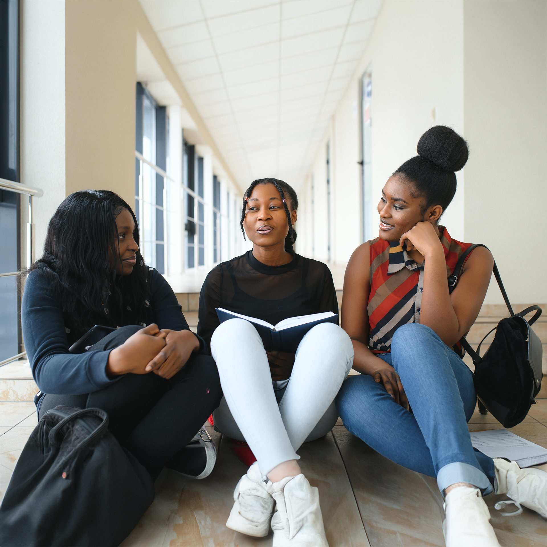 Three girls discussing in hallway